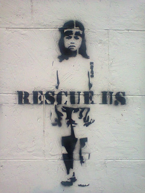 stenciled graffiti of child "rescue us"
